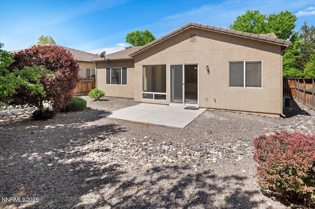10548 Bliss Ct, Reno, NV 89521 - back of property with a fenced backyard, stucco siding, and a patio area