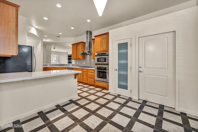 9900 Wilbur May Pkwy Apt 2801, Reno, NV 89521 - kitchen with wall chimney range hood, inlaid floor details, freestanding refrigerator, a peninsula, and light countertops