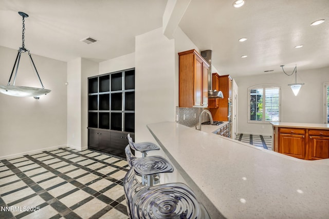 9900 Wilbur May Pkwy Apt 2801, Reno, NV 89521 - kitchen with light countertops, recessed lighting, brown cabinets, baseboards, and pendant lighting
