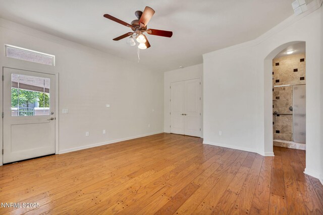 9900 Wilbur May Pkwy Apt 2801, Reno, NV 89521 - empty room featuring arched walkways, ceiling fan, light wood-type flooring, and baseboards