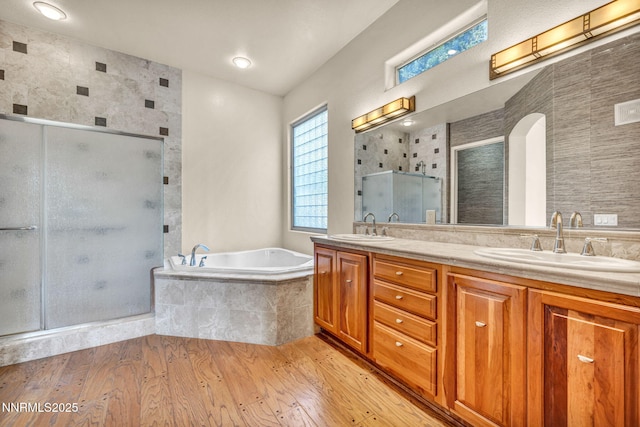 9900 Wilbur May Pkwy Apt 2801, Reno, NV 89521 - bathroom featuring double vanity, a shower stall, a bath, and wood finished floors