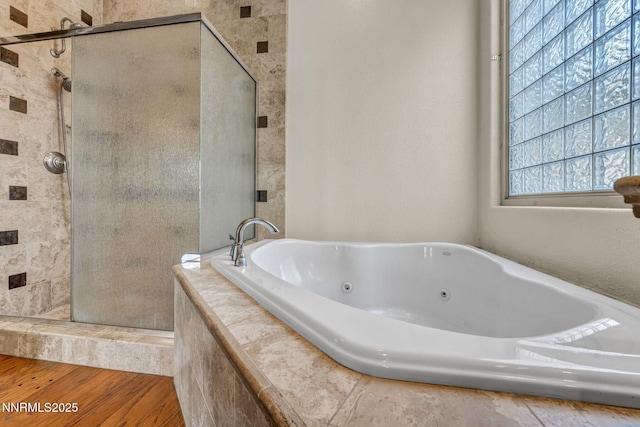 9900 Wilbur May Pkwy Apt 2801, Reno, NV 89521 - full bathroom featuring a shower stall, a whirlpool tub, and wood finished floors