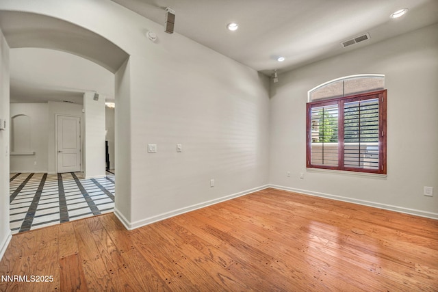 9900 Wilbur May Pkwy Apt 2801, Reno, NV 89521 - empty room with arched walkways, baseboards, light wood finished floors, recessed lighting, and a smoke detector
