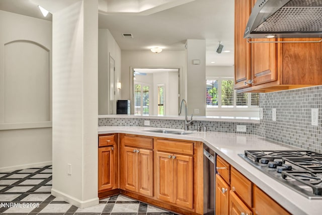 9900 Wilbur May Pkwy Apt 2801, Reno, NV 89521 - kitchen with inlaid floor details, a sink, stainless steel gas cooktop, range hood, and light countertops