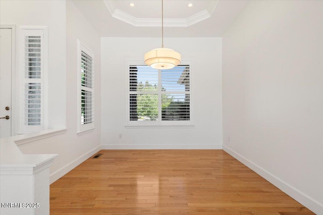 2728 Spirit Rock Trl, Reno, NV 89511 - unfurnished dining area featuring light wood-style flooring, a raised ceiling, baseboards, ornamental molding, and recessed lighting
