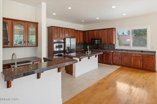 2728 Spirit Rock Trl, Reno, NV 89511 - kitchen with stainless steel appliances, a kitchen breakfast bar, tasteful backsplash, a sink, and recessed lighting