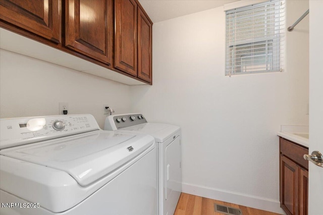 2728 Spirit Rock Trl, Reno, NV 89511 - washroom featuring independent washer and dryer, light wood-type flooring, cabinet space, and baseboards