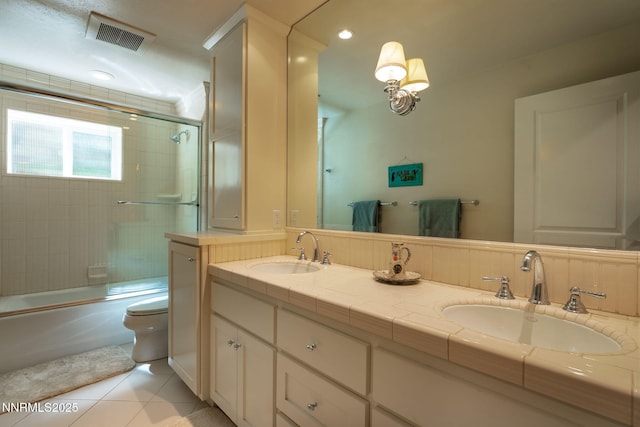 625 Freel Dr, Zephyr Cove, NV 89448 - full bathroom with tile patterned floors, double vanity, bath / shower combo with glass door, and recessed lighting