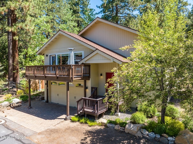 625 Freel Dr, Zephyr Cove, NV 89448 - view of front of property featuring an attached garage, decorative driveway, a wooden deck, and roof with shingles