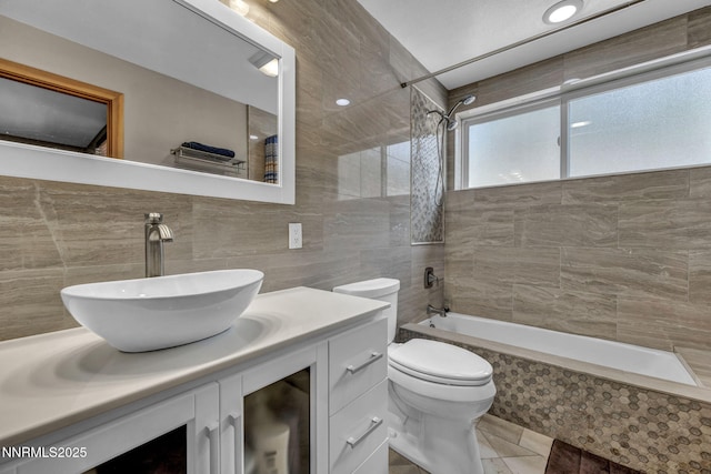 914 Jennifer St, Incline Village, NV 89451 - full bath with tiled shower / bath combo, tile walls, vanity, toilet, and tile patterned floors
