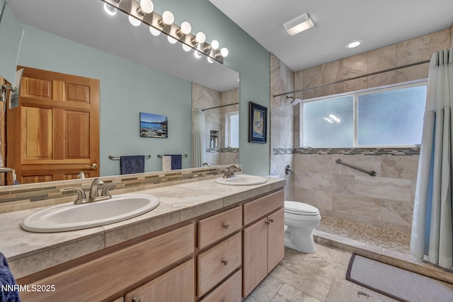 914 Jennifer St, Incline Village, NV 89451 - bathroom featuring a tile shower, toilet, and double vanity