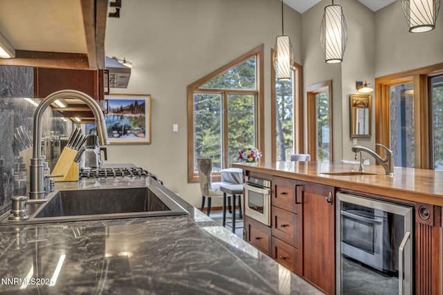 914 Jennifer St, Incline Village, NV 89451 - kitchen featuring wine cooler, a sink, a high ceiling, brown cabinetry, and oven