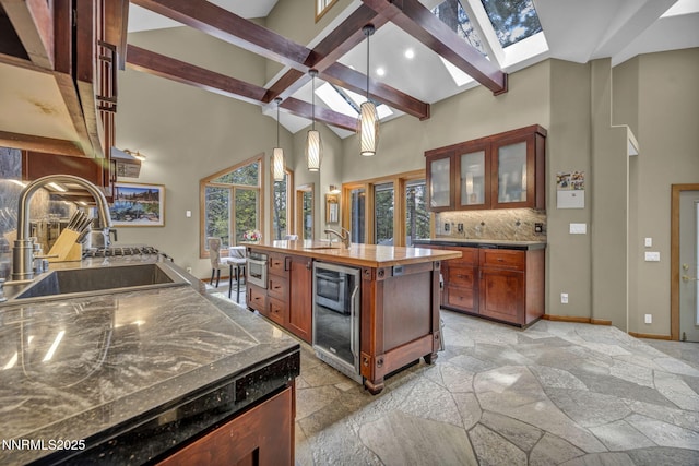 914 Jennifer St, Incline Village, NV 89451 - kitchen with a sink, a skylight, stone tile floors, beam ceiling, and plenty of natural light