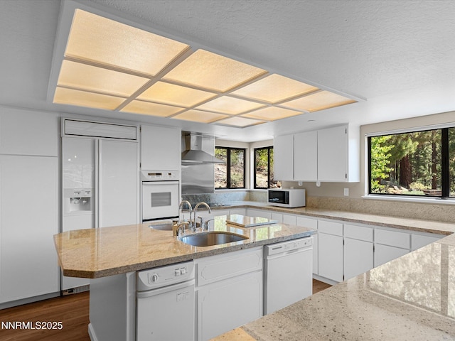 315 Paiute Dr, Zephyr Cove, NV 89448 - kitchen with white appliances, wall chimney range hood, dark wood finished floors, plenty of natural light, and a textured ceiling