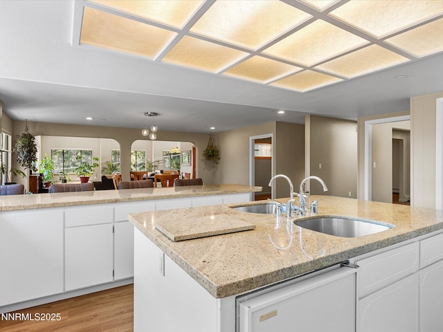 315 Paiute Dr, Zephyr Cove, NV 89448 - kitchen with dishwasher, light wood-style flooring, recessed lighting, white cabinets, and an island with sink
