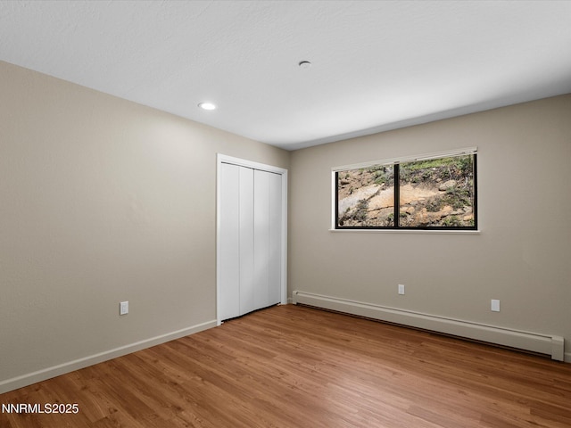 315 Paiute Dr, Zephyr Cove, NV 89448 - unfurnished bedroom featuring baseboard heating, light wood-type flooring, a closet, and recessed lighting