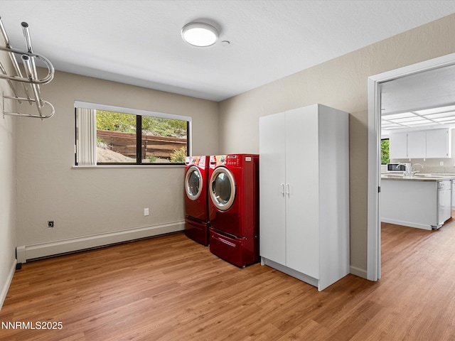 315 Paiute Dr, Zephyr Cove, NV 89448 - laundry room featuring separate washer and dryer, light wood-style flooring, a chandelier, and a baseboard radiator