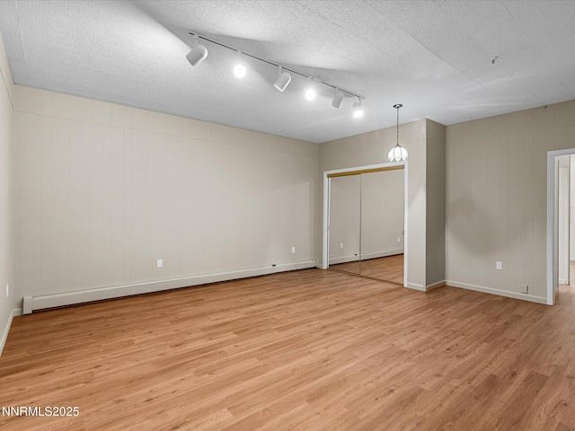 315 Paiute Dr, Zephyr Cove, NV 89448 - unfurnished room featuring light wood finished floors, baseboard heating, and track lighting
