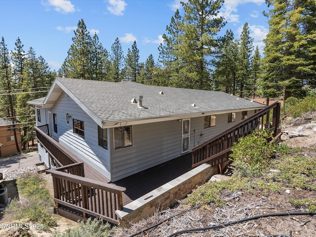 315 Paiute Dr, Zephyr Cove, NV 89448 - rear view of house featuring a shingled roof and stairway