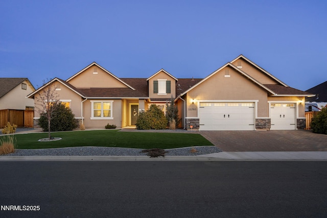 11760 Valley Crest Dr, Sparks, NV 89441 - view of front of home featuring stone siding, driveway, an attached garage, and stucco siding
