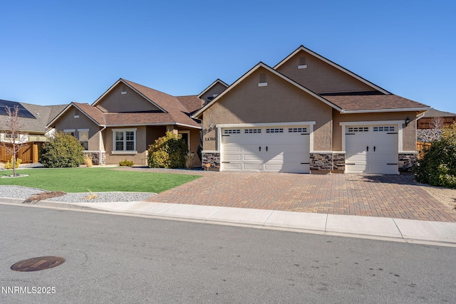 11760 Valley Crest Dr, Sparks, NV 89441 - view of front facade with stone siding, an attached garage, decorative driveway, and stucco siding