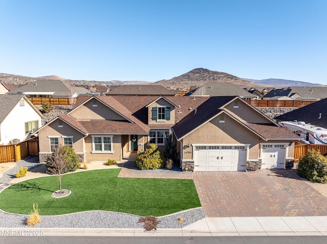 11760 Valley Crest Dr, Sparks, NV 89441 - view of front facade featuring stone siding, stucco siding, decorative driveway, an attached garage, and a mountain view