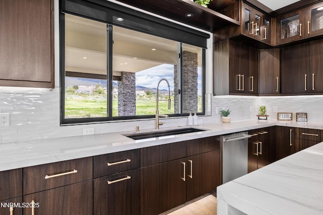 3041 Palmer Pointe Ct, Reno, NV 89511 - kitchen with a sink, light stone countertops, dark brown cabinetry, and backsplash