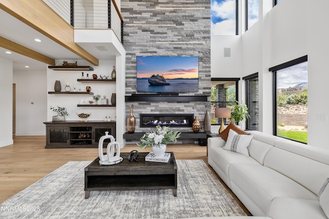 3041 Palmer Pointe Ct, Reno, NV 89511 - living area featuring plenty of natural light, wood finished floors, a fireplace, a high ceiling, and recessed lighting
