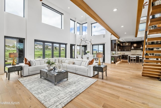 3041 Palmer Pointe Ct, Reno, NV 89511 - living room featuring a chandelier, a high ceiling, recessed lighting, and light wood finished floors