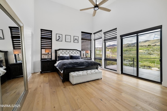 3041 Palmer Pointe Ct, Reno, NV 89511 - bedroom with a towering ceiling, access to outside, and light wood-style floors