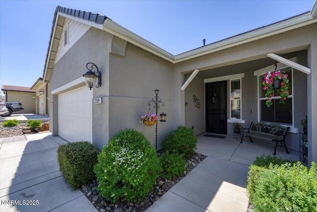 2269 Isabella Ct, Sparks, NV 89434 - entrance to property with a garage, stucco siding, and a porch