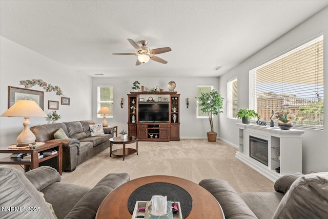 2269 Isabella Ct, Sparks, NV 89434 - living area featuring light carpet, ceiling fan, a glass covered fireplace, and baseboards