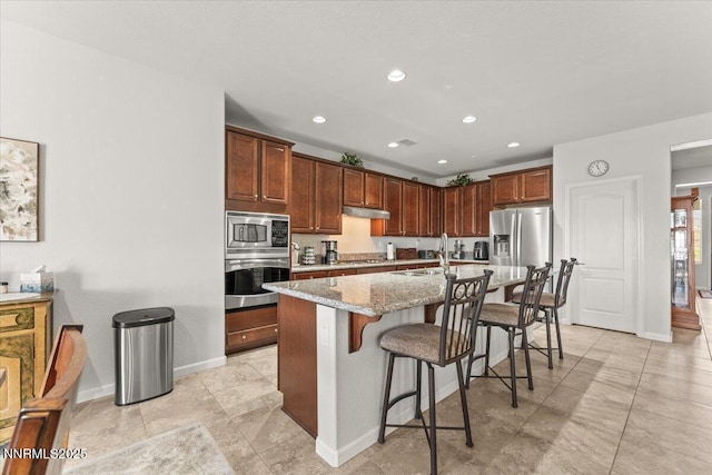 2269 Isabella Ct, Sparks, NV 89434 - kitchen featuring stainless steel appliances, a kitchen breakfast bar, a sink, baseboards, and under cabinet range hood
