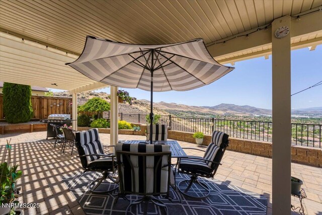 2269 Isabella Ct, Sparks, NV 89434 - view of patio with outdoor dining area, a mountain view, and a grill