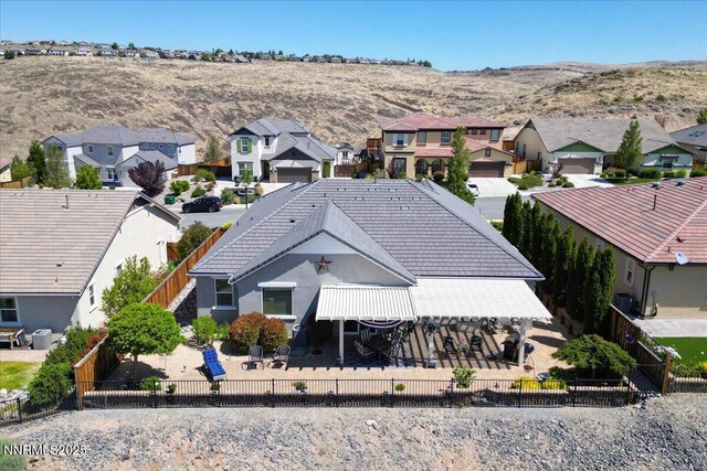 2269 Isabella Ct, Sparks, NV 89434 - rear view of house featuring a residential view, a fenced backyard, a patio area, and a tiled roof