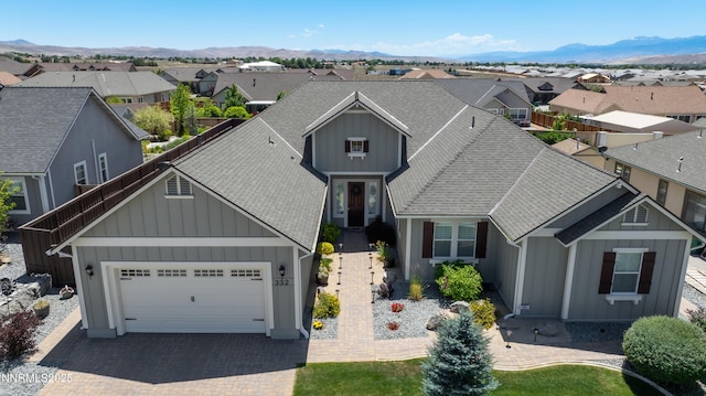 332 Blooming Sage Way, Spanish Springs, NV 89441 - traditional-style home with board and batten siding, a residential view, an attached garage, roof with shingles, and a mountain view