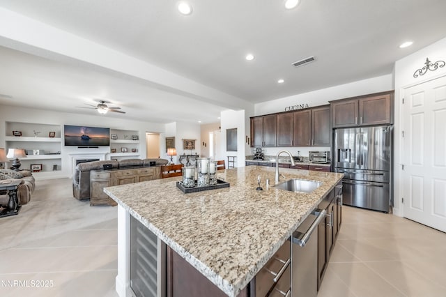 332 Blooming Sage Way, Spanish Springs, NV 89441 - kitchen with stainless steel appliances, light tile patterned flooring, recessed lighting, dark brown cabinets, and light stone countertops