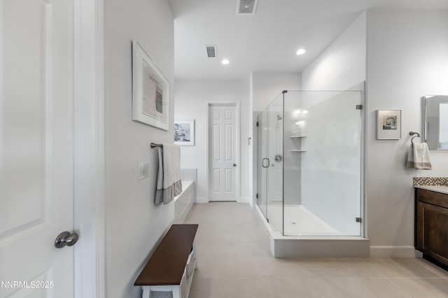332 Blooming Sage Way, Spanish Springs, NV 89441 - bathroom featuring vanity, a shower stall, a garden tub, tile patterned flooring, and recessed lighting