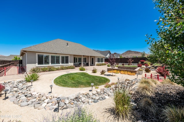 332 Blooming Sage Way, Spanish Springs, NV 89441 - back of house with stucco siding and a garden