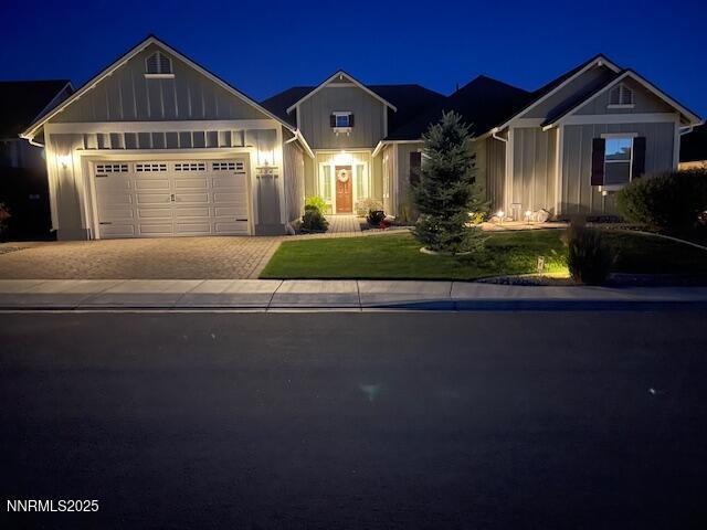 332 Blooming Sage Way, Spanish Springs, NV 89441 - view of front of home featuring board and batten siding, driveway, an attached garage, and a lawn