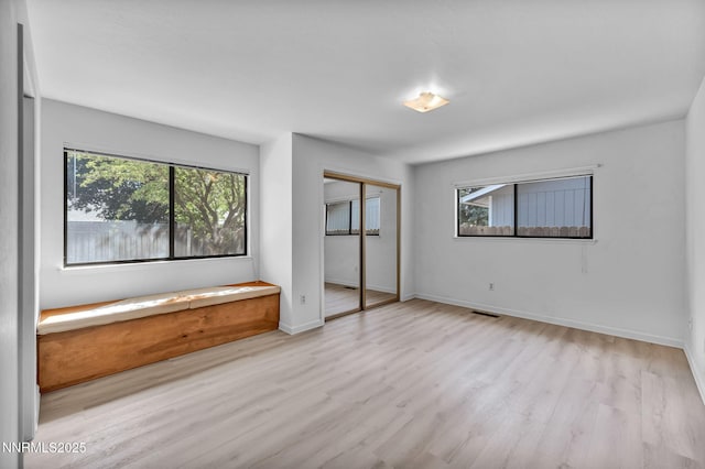 3803 Imperial Way, Carson City, NV 89706 - unfurnished bedroom featuring multiple windows, wood finished floors, baseboards, and a closet