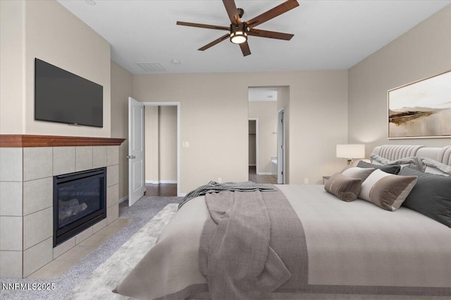 5345 Energystone Dr, Sparks, NV 89436 - carpeted bedroom featuring a tiled fireplace and a ceiling fan