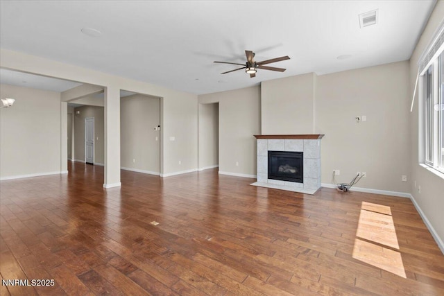 5345 Energystone Dr, Sparks, NV 89436 - unfurnished living room featuring ceiling fan, a tile fireplace, and hardwood / wood-style floors