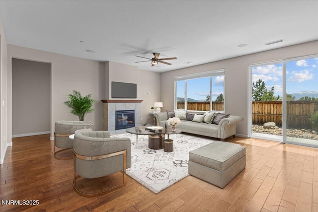 5345 Energystone Dr, Sparks, NV 89436 - living area with wood finished floors, a ceiling fan, and a fireplace