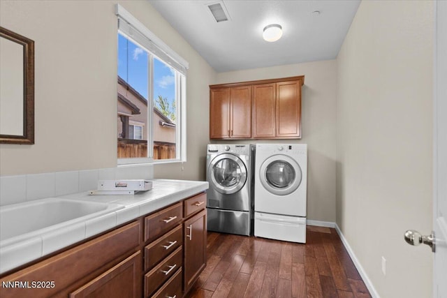 5345 Energystone Dr, Sparks, NV 89436 - laundry area featuring washing machine and clothes dryer, cabinet space, and dark wood-style flooring