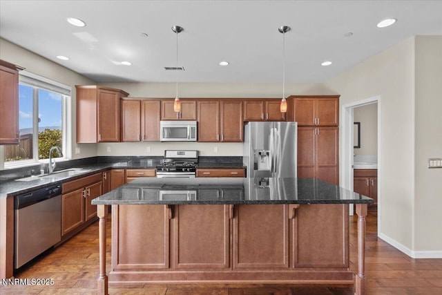 5345 Energystone Dr, Sparks, NV 89436 - kitchen with stainless steel appliances, a center island, wood finished floors, recessed lighting, and decorative light fixtures