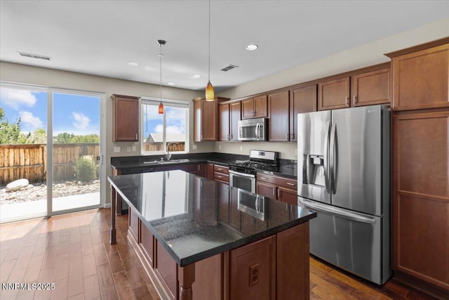5345 Energystone Dr, Sparks, NV 89436 - kitchen featuring appliances with stainless steel finishes, dark wood-style flooring, a center island, recessed lighting, and decorative light fixtures