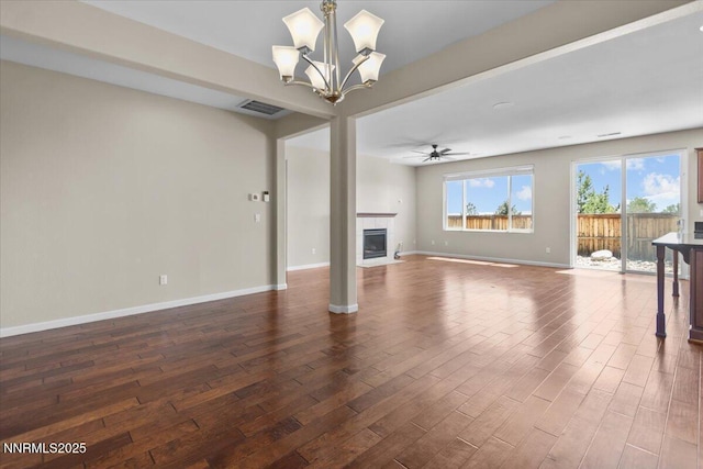 5345 Energystone Dr, Sparks, NV 89436 - unfurnished living room with dark wood finished floors, a tile fireplace, a chandelier, and ceiling fan