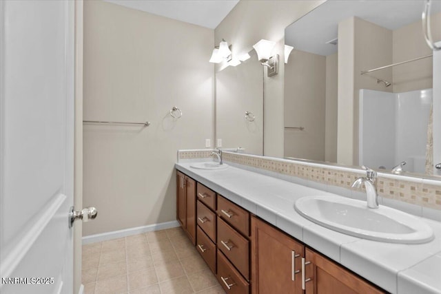 5345 Energystone Dr, Sparks, NV 89436 - full bath featuring double vanity, tile patterned floors, a shower, and tasteful backsplash