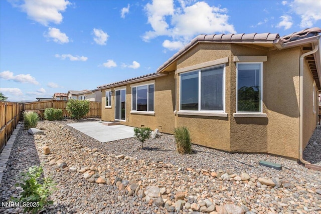 5345 Energystone Dr, Sparks, NV 89436 - back of house with stucco siding, a patio, a fenced backyard, and a tile roof